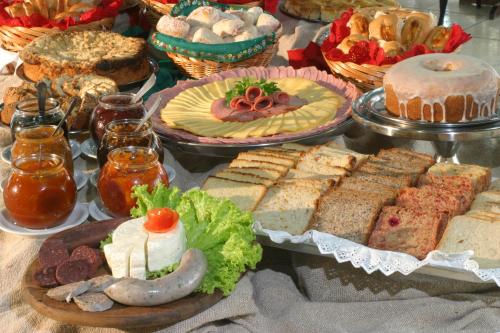 a table topped with lots of different types of food at Hotel Rieger in Balneário Camboriú