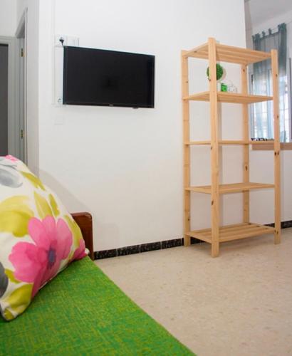 a living room with a flat screen tv on a wall at Apartamentos Calypso in Punta Umbría
