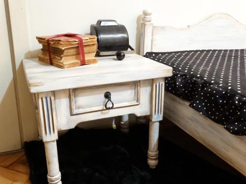 a table with a chest next to a bed at ROYAL apartment in Gabrovo