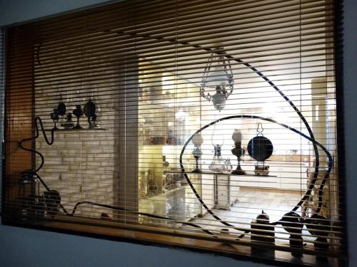 a window with a view of a shelf with birds in it at ROYAL apartment in Gabrovo