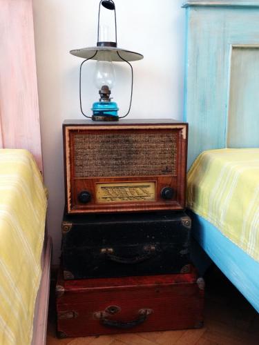 a lamp on top of a dresser next to two beds at ROYAL apartment in Gabrovo