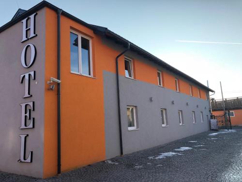 an orange and gray building with a door at Hotel Vogelweiderhof in Salzburg