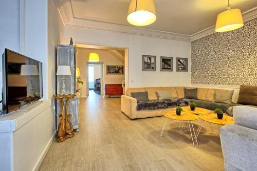 a living room with a couch and a table at São Pedro 30 Guests Apartment in Lisbon