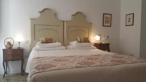 a bedroom with a large bed with two pillows at Los Canaritos in Las Palmas de Gran Canaria