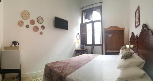 a bedroom with a large bed and a window at Los Canaritos in Las Palmas de Gran Canaria