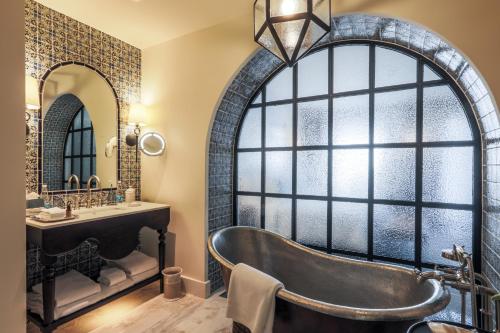 a bathroom with a large window and a tub at Banyan Tree Puebla in Puebla