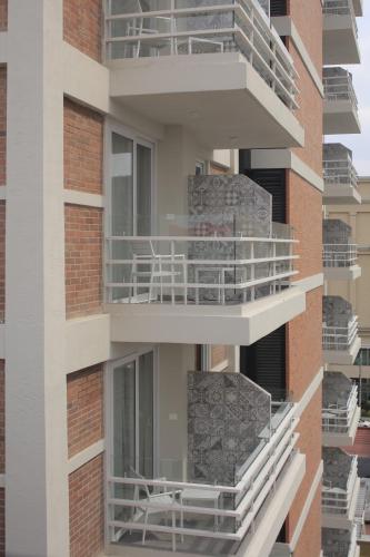 an external view of a building with balconies at Hotel Velvet Plaza in Guadalajara