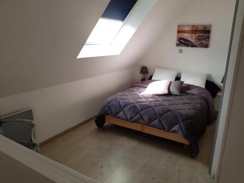 a bedroom with a bed and a skylight at la verte vallée 2 in Munster