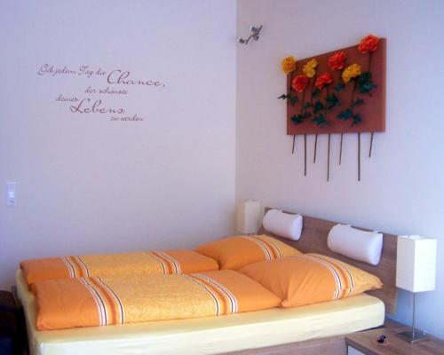 a room with a couch with flowers on the wall at Badische Landoase in Kehl am Rhein