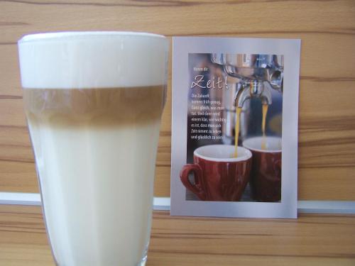 a glass of milk next to a coffee machine at Badische Landoase in Kehl am Rhein