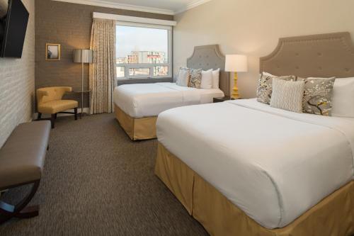 a hotel room with two beds and a window at The Mark Spencer Hotel in Portland