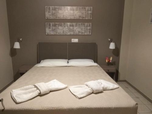 a bedroom with a bed with two towels on it at Villa Rododafni in Roda