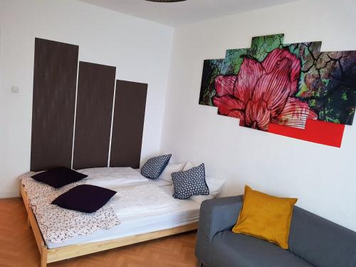 Cama en habitación con sofá y pintura en GreatStay Saarbrücken, en Saarbrücken