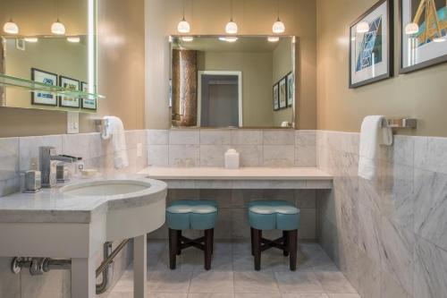 a bathroom with a sink and a large mirror at The Mark Spencer Hotel in Portland