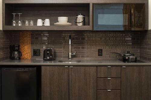 a kitchen with a sink and a microwave at The Mark Spencer Hotel in Portland