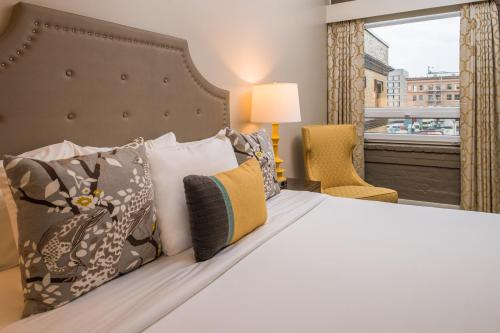a bedroom with a bed with pillows and a window at The Mark Spencer Hotel in Portland