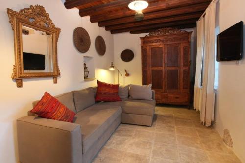 a living room with a couch and a mirror at “Imagine Renting this Luxury Villa” Troodos Mountains Home 119 in Kalopanayiotis