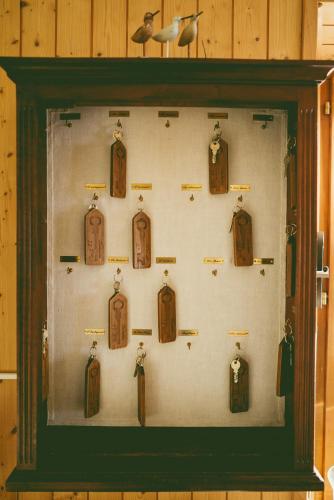 a display case filled with different types of clocks at Hôtel de la Chaux-d'Abel in La Ferrière