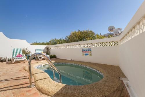 a swimming pool with a slide in a backyard at Casa Tulipa in Luz