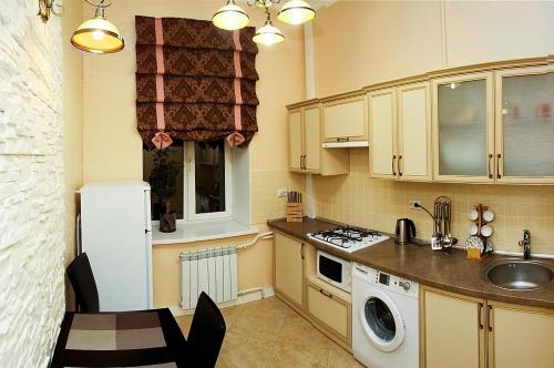 a small kitchen with a white refrigerator and a sink at Kiev Centre Apartments in Kyiv