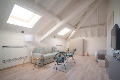 a living room with a couch and a table and chairs at Comonfive Apartments in Como