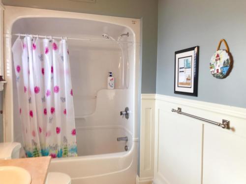 a bathroom with a shower with a shower curtain at Sweet home in Moncton