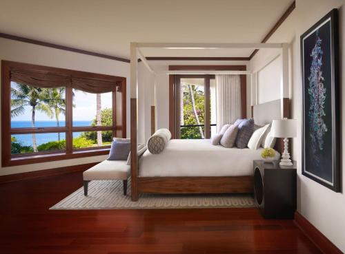 a bedroom with a bed and a view of the ocean at Montage Kapalua Bay in Kapalua