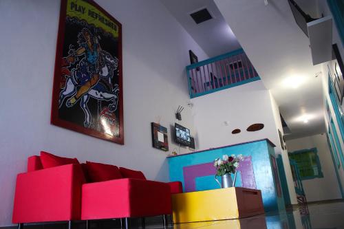 a living room with a couch and a painting on the wall at Hostal Johnnier Macao Punta Cana in Punta Cana