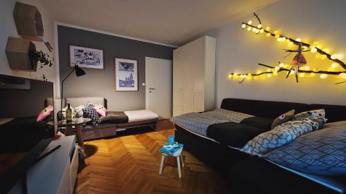 a bedroom with two beds and lights on the wall at Apartmán Loty in Tatranská Lomnica