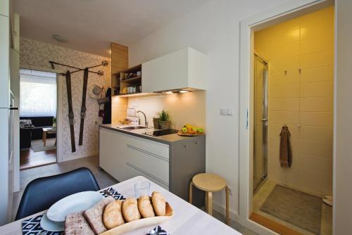 a small kitchen with a table with bread on it at Apartmán Loty in Tatranská Lomnica