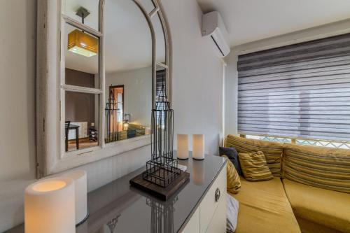 sala de estar con sofá y espejo en Apartamento con encanto en Granada, La Zubia, en La Zubia