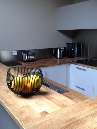 a bowl sitting on top of a counter in a kitchen at Chambre d'hôtes La Font in Eygliers