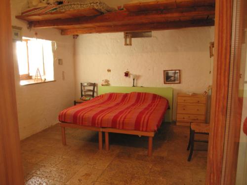 A bed or beds in a room at Masseria dei Monelli