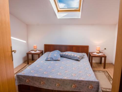 a bedroom with a bed and two night stands at Apartment Stana in Novi Vinodolski