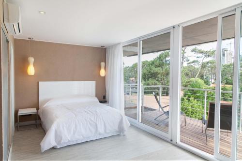 a bedroom with a bed and a large window at 2122 Hotel Art Design in Punta del Este