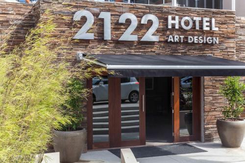 a hotel with a black awning in front of a building at 2122 Hotel Art Design in Punta del Este
