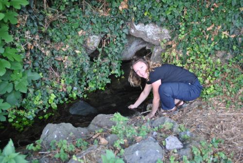 a woman kneeling in front of a small cave at Agriturismo Borgo San Nicolao in Randazzo