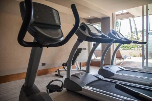 a gym with three treadmill machines in a room at 2122 Hotel Art Design in Punta del Este