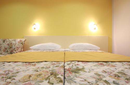 a bed with two pillows on top of it at Hotel Sali in Sali