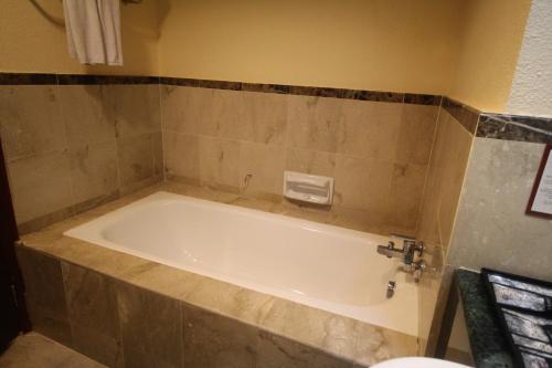 a bathroom with a bath tub in a bathroom at Grand Riverview Hotel in Kota Bharu