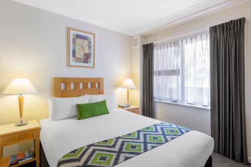 a hotel room with a bed and a window at Nesuto Mounts Bay in Perth