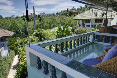 a view from the balcony of a house with a swimming pool at Gila's Garden in Lamai