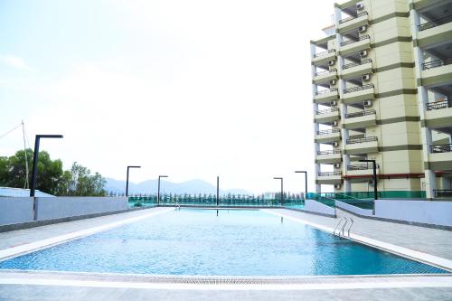 an empty swimming pool in front of a building at Marina Heights Resort in Lumut