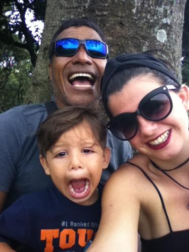 a man and a woman and a child posing for a picture at Miguel Surf Camp in Quepos