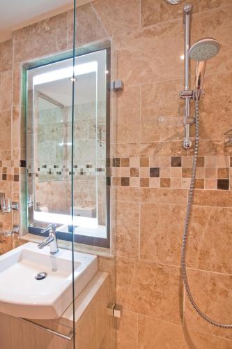 a bathroom with a sink and a shower at Portland Apartments in Cheltenham