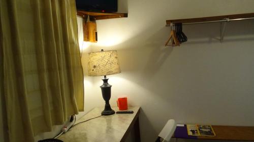 a lamp sitting on a desk in a room at Hacienda Tropical Guest House in Belmopan