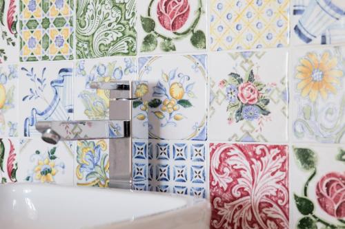 a bathroom with colorful tiles on the wall and a sink at Mare Cielo in Xiaoliuqiu