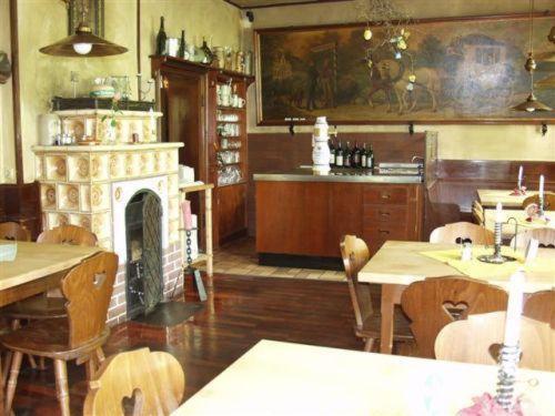 a room with a fireplace and tables and chairs at Ab ins Postkutscherl in Würzburg