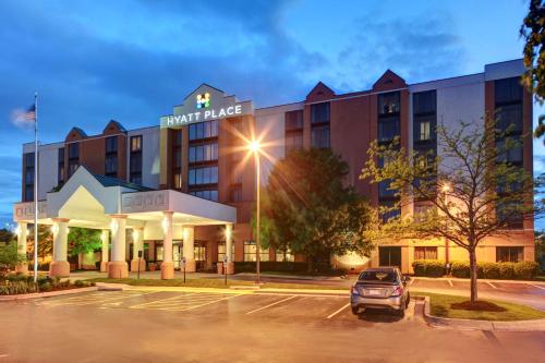 a hotel with a car parked in a parking lot at Hyatt Place Denver Airport in Aurora