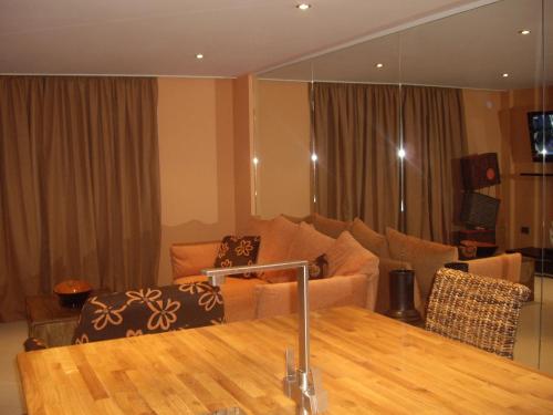a living room with a couch and a table at Portland Apartments in Cheltenham